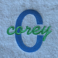 embroidered boys name in cursive on ivory baby blanket