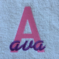 embroidered girls name in cursive on baby blanket with white trim